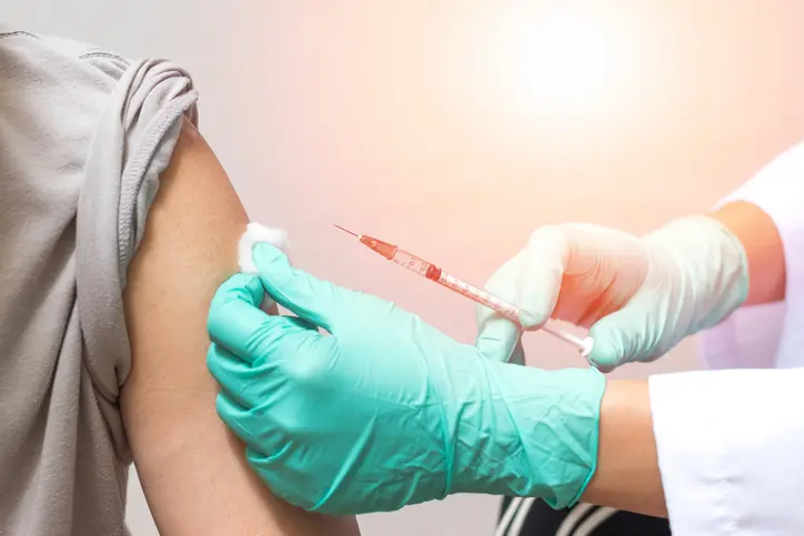 Vaccination healthcare concept. Hands of doctor or nurse in medical gloves injecting a shot of vaccine to a man patient (Vaccination healthcare concept. Hands of doctor or nurse in medical gloves injecting a shot of vaccine to a man patient, ASCII, 12